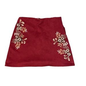 Red velvet skirt with small floral accents